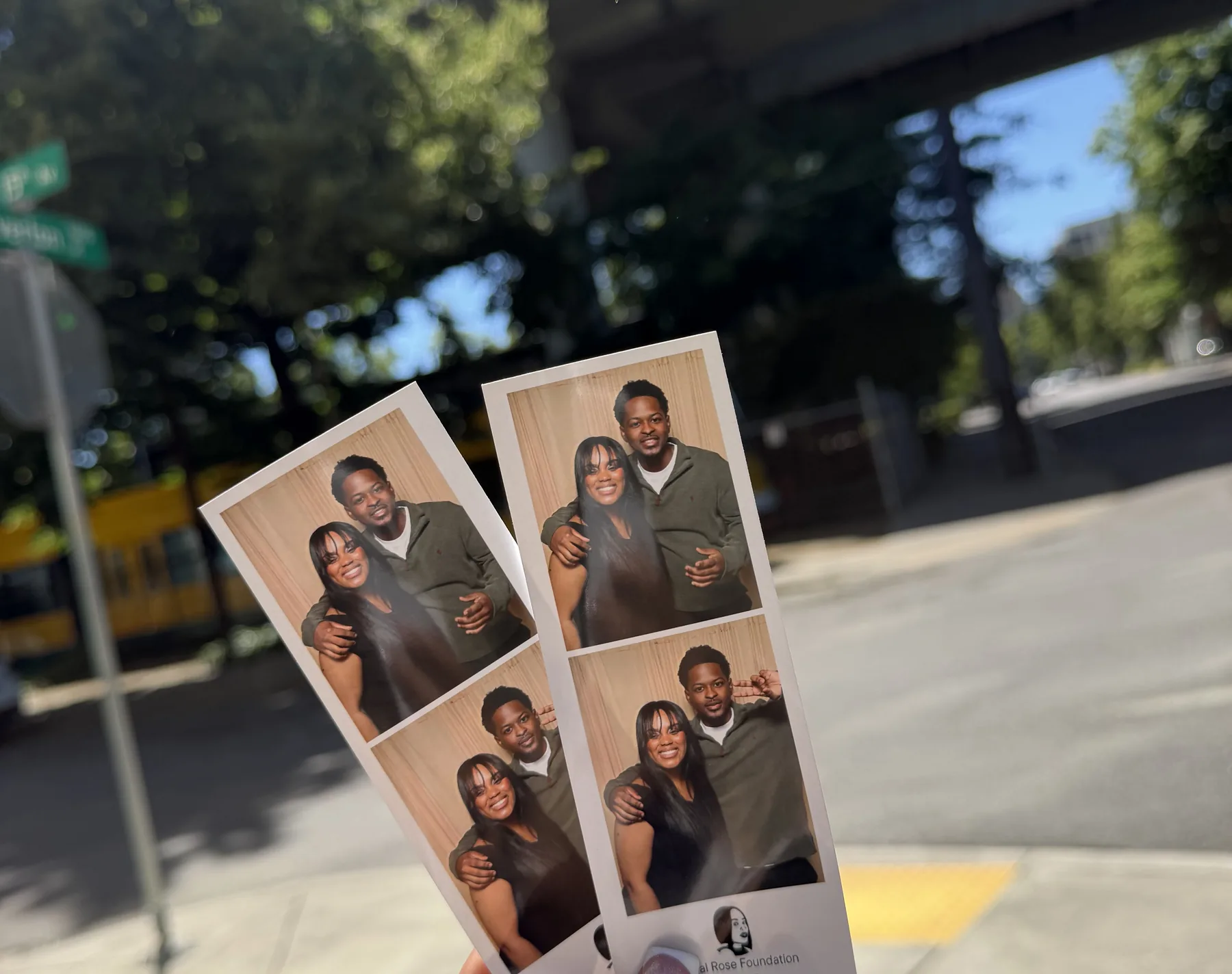 A guest holding their photo booth prints outside the venue.
