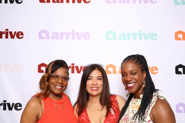 Two guests laughing together at a corporate event.
