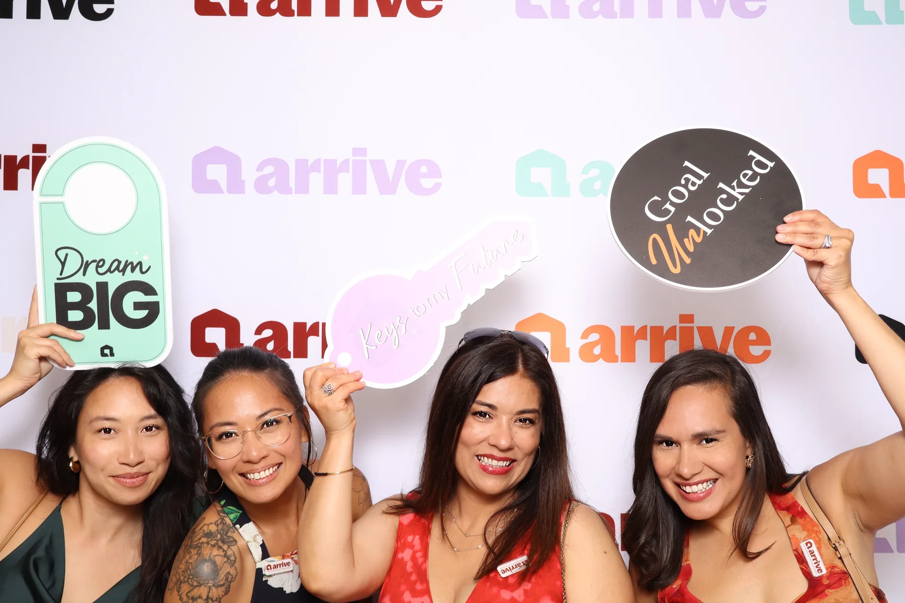 Guests holding printed sign props at a corporate event.
