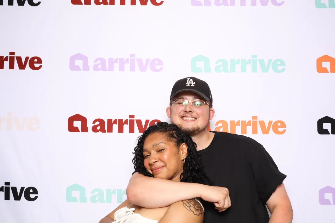 Two guests hugging at a corporate event.