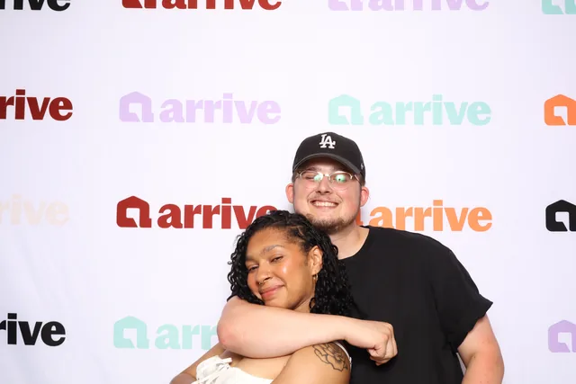 Two guests hugging at a corporate event.