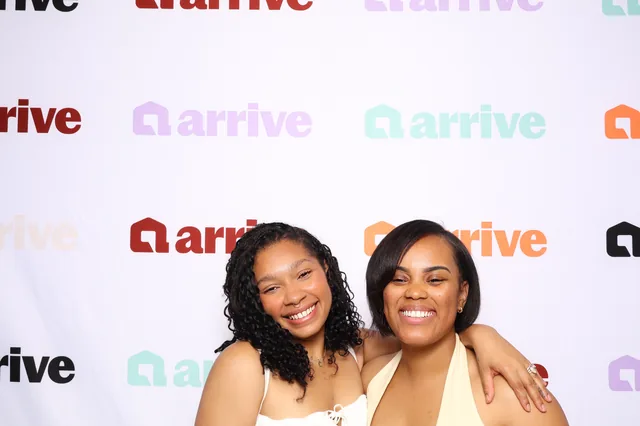 Two guests posing together at a corporate event.